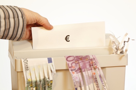 to devalue a currency with shredder symbolの写真素材