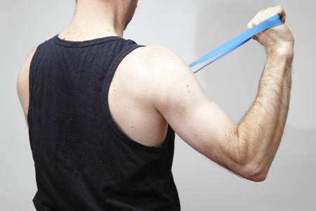 Young caucasian male in sportswear doing excercisesの写真素材