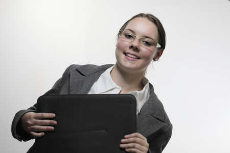 Young female student with notebook and white backgroundの写真素材