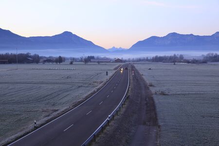 cars on the street on a cold autumn morningの写真素材