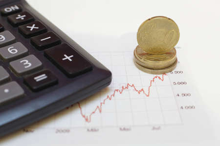 Graphs, charts, business table with money coinsの写真素材