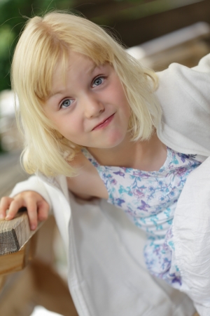 a young girl is looking sceptic to cameraの写真素材
