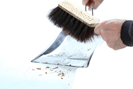 hands holding broom and dust pan sweeping upの写真素材