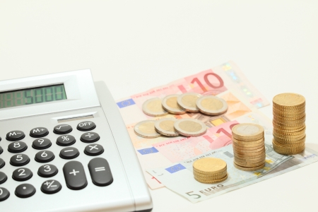 cash calculating with calculator and money on deskの写真素材