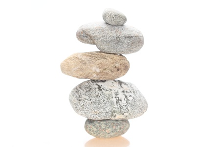 symbolic stone tower in balance with white background
