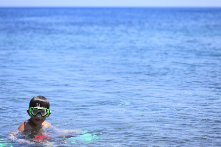 a boy is diving in the oceanの写真素材