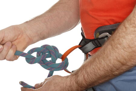 climber is binding a knot on belt