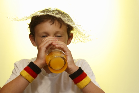 boy is drinking and get a water splashの写真素材