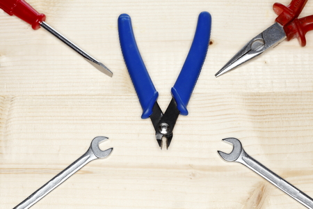 different colored tools on a wooden plate