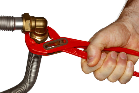 worker is fixing a pipe with gripper tool