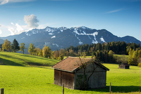 mountain landscape with hovel and green fieldsの写真素材
