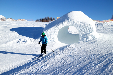 woman is skiing on a sunny day in the dolomites