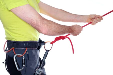 sport climber is testing the rope knot