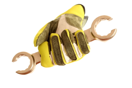 yellow glove with wrench on white backgroundの写真素材