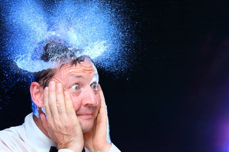 surprised business man with blue water hatの写真素材