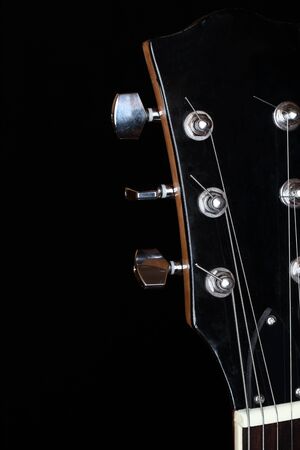 head plate of an electric guitar on black backgroundの写真素材