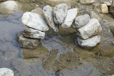 some stones formed as a bridge over waterの写真素材