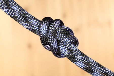 one knot with rope on wooden plateの写真素材