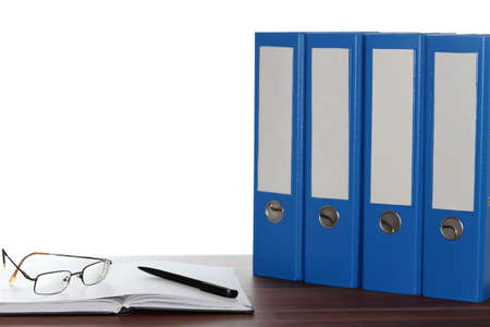 work desk with glasses and file foldersの写真素材