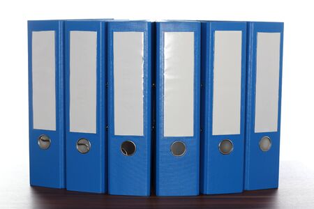 six file folders on a wooden plateの写真素材