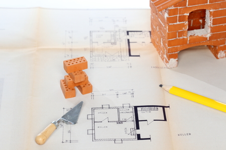 some tools and bricks on a blue printの写真素材
