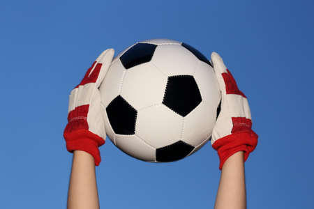 goalkeeper with ball and blue sky backgroundの写真素材