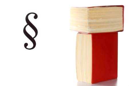 law and right symbol with law book in background