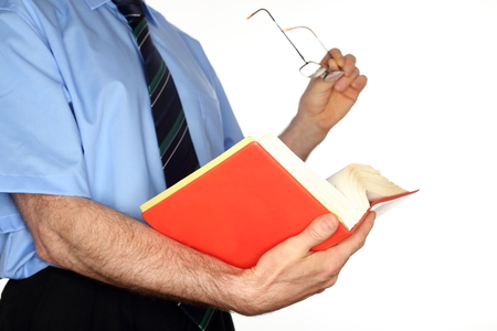 businessman is looking in a book with glasses in ahndの写真素材