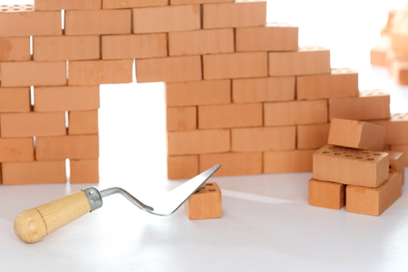building a house with bricks and toolの写真素材