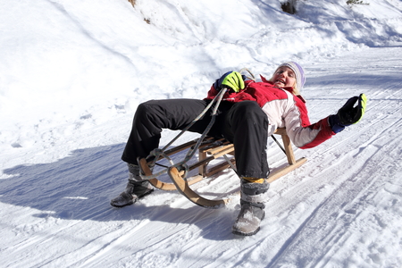 teenager have fun with sledge in winterの写真素材