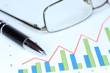 pencil and chart with eyeglasses on a desk