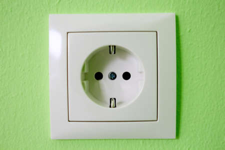 one electrical device mounted on a green wallの写真素材
