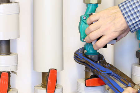 worker is mounting a new pump on a pipeの写真素材