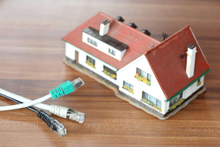 some network cables in front of a house modelの写真素材