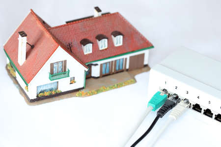 network symbol with plugs and house in backgroundの写真素材