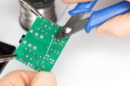 cutting a wire on an electrical card, detail view