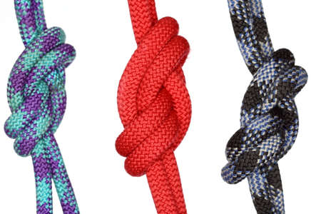 three different colored rope knots on white background