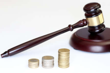 gavel and money coins on white backgroundの写真素材