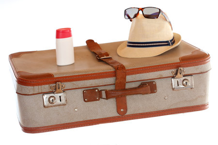 travel bag with sunmilk and hat and sunglassesの写真素材