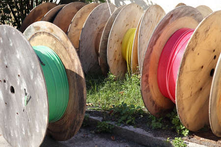 some cable drums with different colored pipesの写真素材