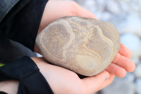 colored stone in hand of a child