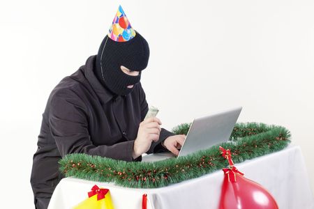 Man stealing data from a laptopの写真素材