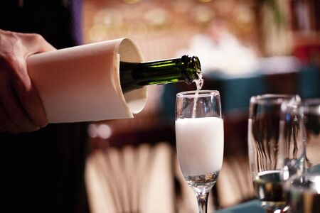 Pouring champagne into a glassの写真素材
