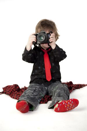 Cute child taking photos on a white backgroundの写真素材