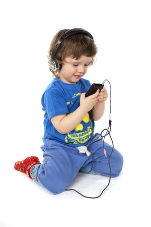 Cute child with headphones and a Mp3 player in handsの写真素材