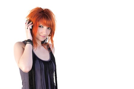 Redhead young woman holding headphonesの写真素材