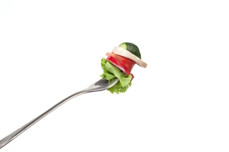 Pieces of vegetables stuck in a fork の写真素材