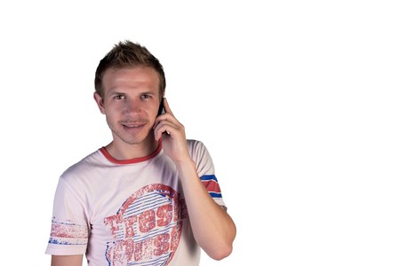 Boy talking on the phone on a white backgroundの写真素材