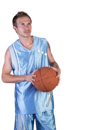 Basketball player posing with ball in hand on a white backgroundの写真素材