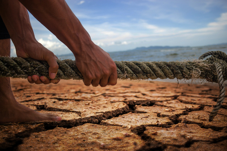 Hand pull a rope drag water, Drought be lost.の写真素材